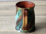 Pottery mug detail showing turquoise glaze movement and speckled texture, handmade ceramics