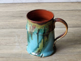 Handmade ceramic latte mug with ocean-green glaze and dark brown rim, unique one-of-a-kind piece