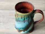 One-of-a-kind handmade mug in earthy green teal tones with rust coloured interior
