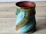 Wheel-thrown ceramic mug with painterly glaze movement, studio pottery style