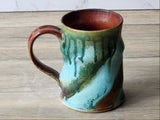 Australian handmade pottery mug with green glaze drips and comfortable handle