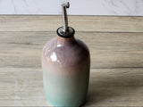Glazed ceramic oil bottle with metal pour spout, minimalist kitchen styling
