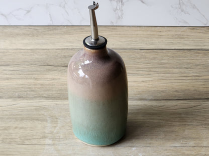 Ceramic olive oil bottle with green glaze and brown accents, handmade in Melbourne Australia