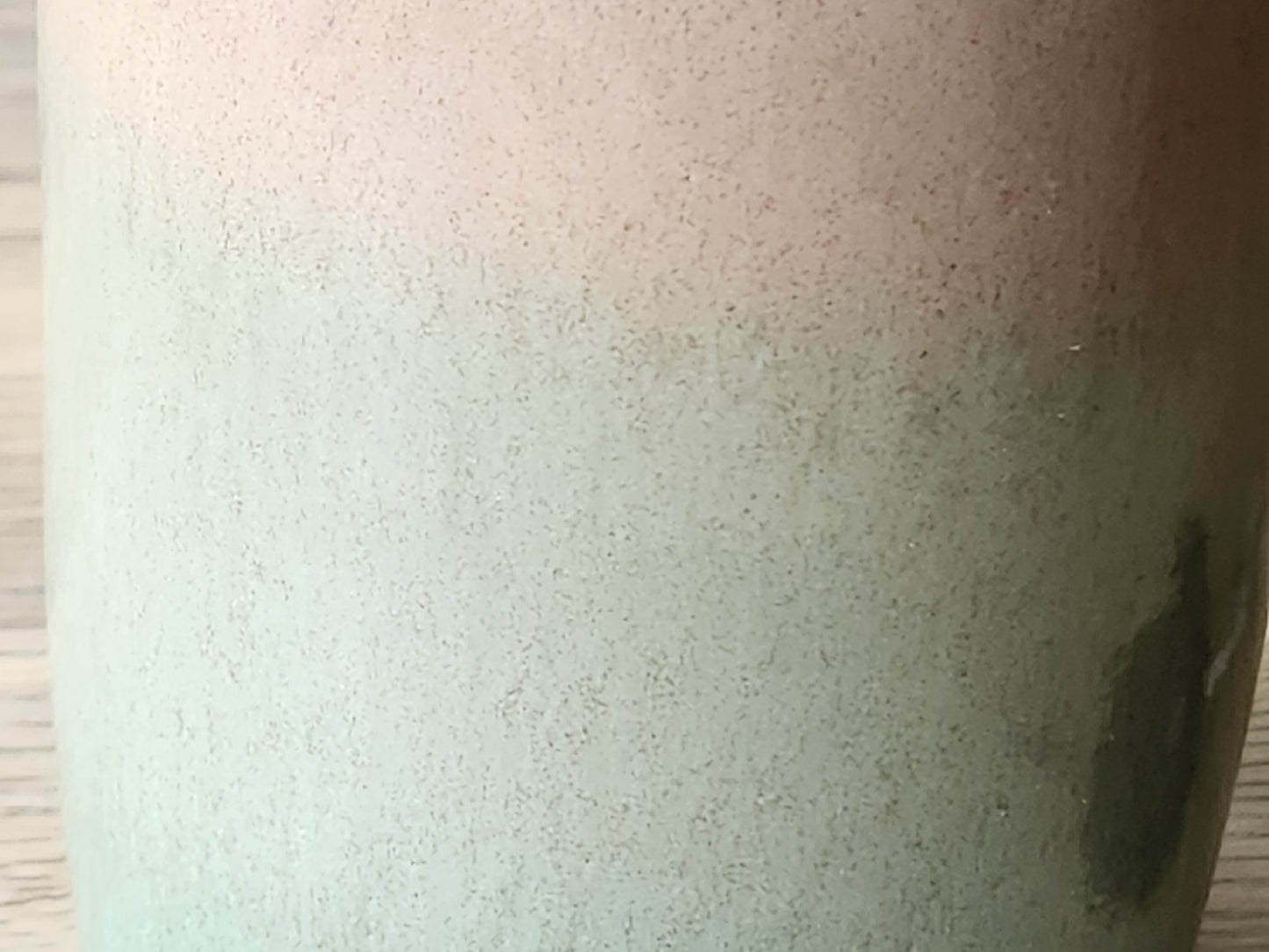 Detail of handmade ceramic oil cruet glaze in green and brown, unique artisan pottery piece