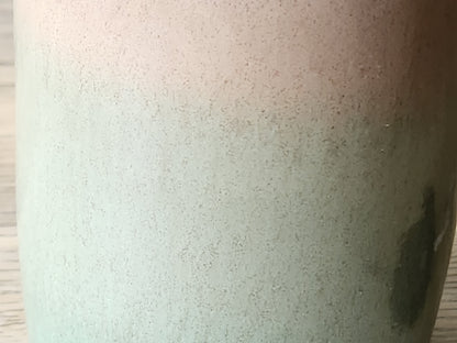 Detail of handmade ceramic oil cruet glaze in green and brown, unique artisan pottery piece