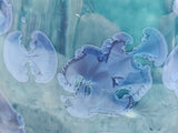 Detailed close-up of layered aqua and cobalt crystal glaze on pottery mug