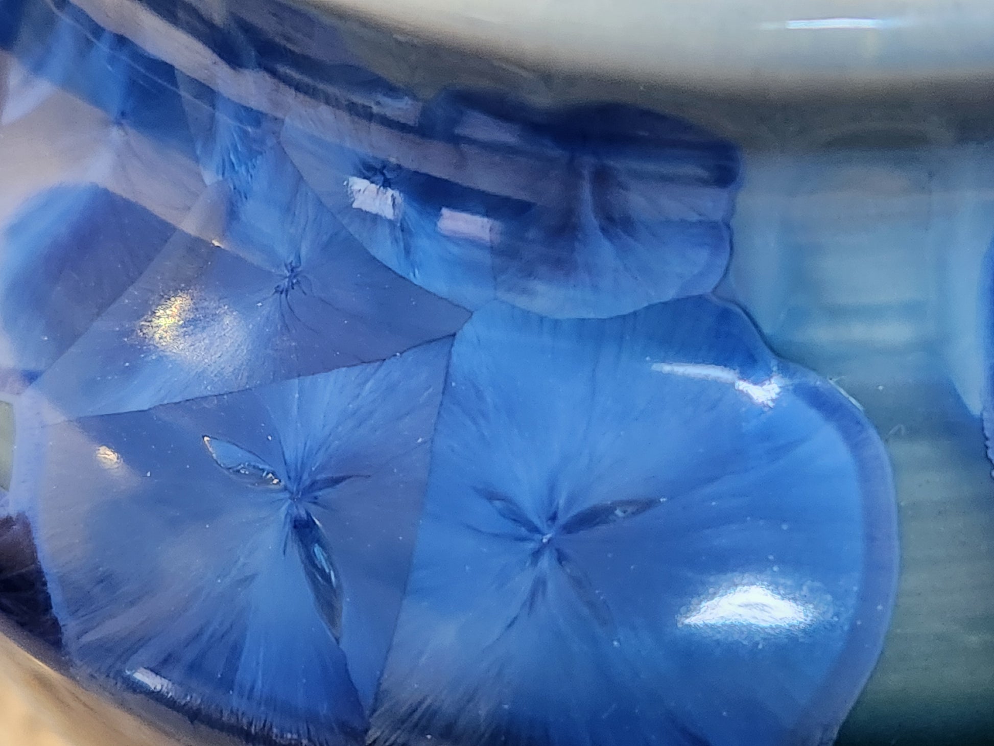 Close-up of blue crystal glaze on handmade ceramic vase