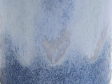 Close up of the mottled blue glaze of a small bud vase