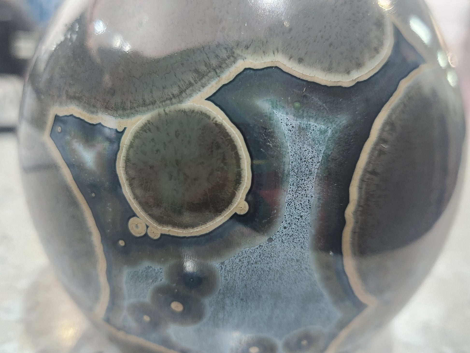 Close-up of oversized crystals on handmade galaxy glaze vase