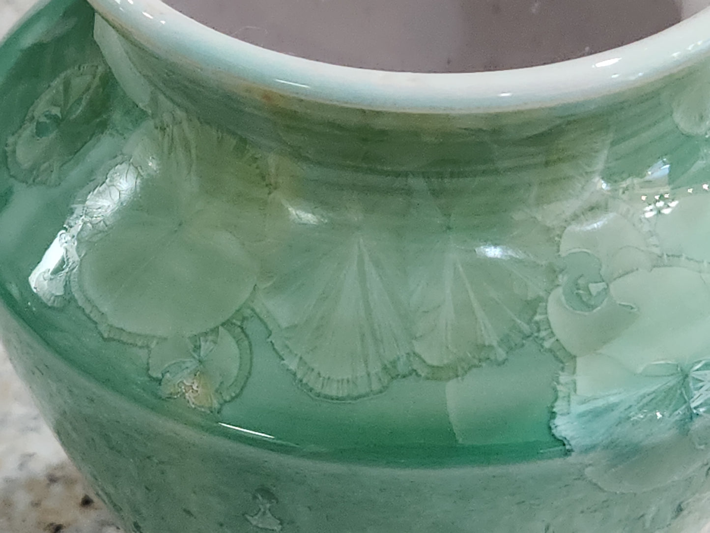 Close-up of crystalline glaze detail on handmade green pottery vase