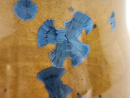 Unique crystals shown close up on a blue on Amber handmade vase, made in Melbourne, Australia.
