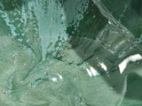 Close up of Mottled green ceramic divided bowl handcrafted in Melbourne, showcasing unique glaze movement and artisan craftsmanship.