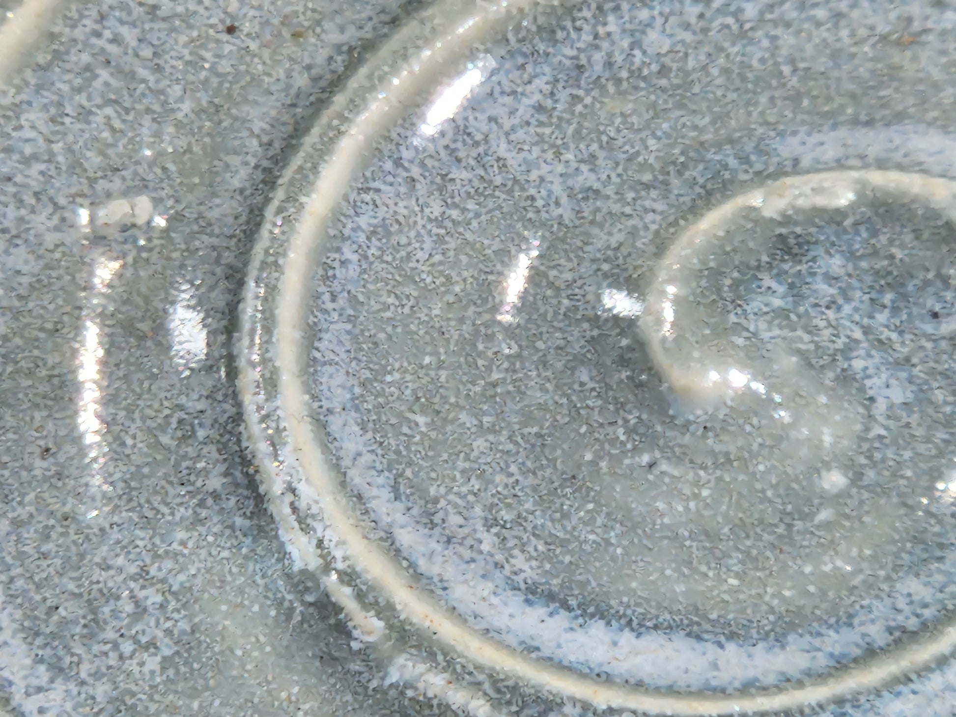 Close-up of glossy micro-crystal grey blue glaze on handmade pottery spoon rest