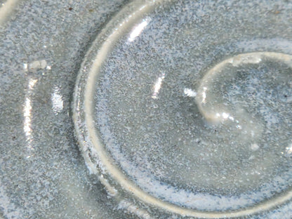 Close-up of glossy micro-crystal grey blue glaze on handmade pottery spoon rest