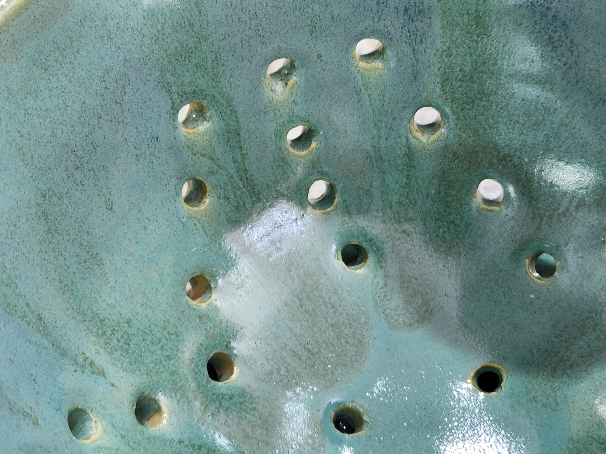 Close-up of spearmint green berry bowl with drainage holes
