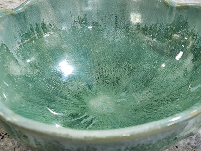 Close-up of layered spearmint and seafoam green glaze on handmade pottery bowl