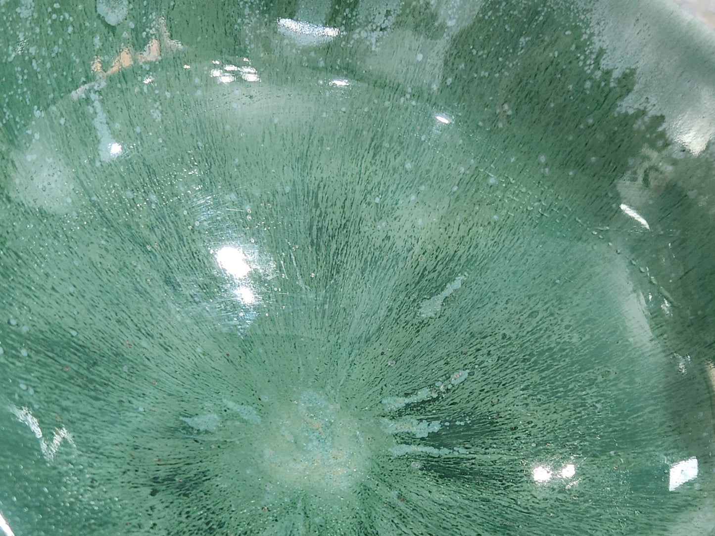close up of glaze on a Handmade green pottery bowl for salads vegetables and shared dishes