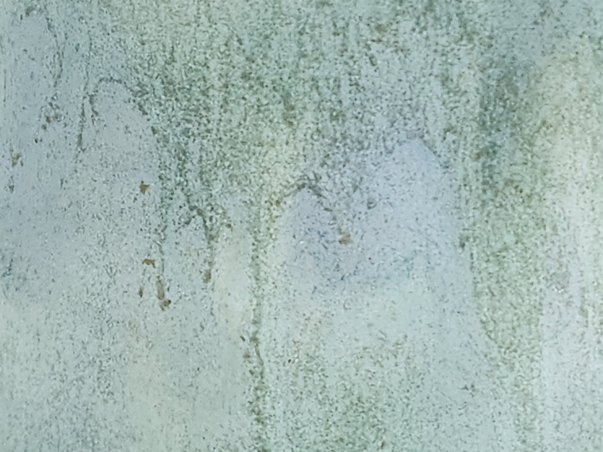 Close-up of mottled green and blue glaze on handmade jug