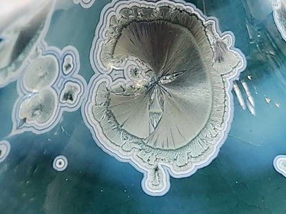 Close up of detail showingflower like scattered crystals on the shoulder of the handmade vase