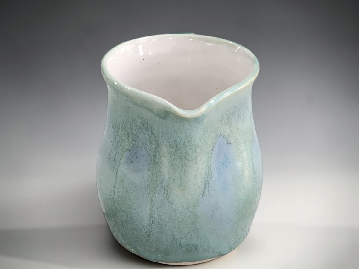 Sea-green ceramic cream jug with soft blue glaze details