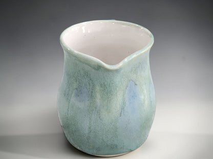 Sea-green ceramic cream jug with soft blue glaze details