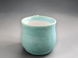 Handmade pottery cup in glossy green glaze