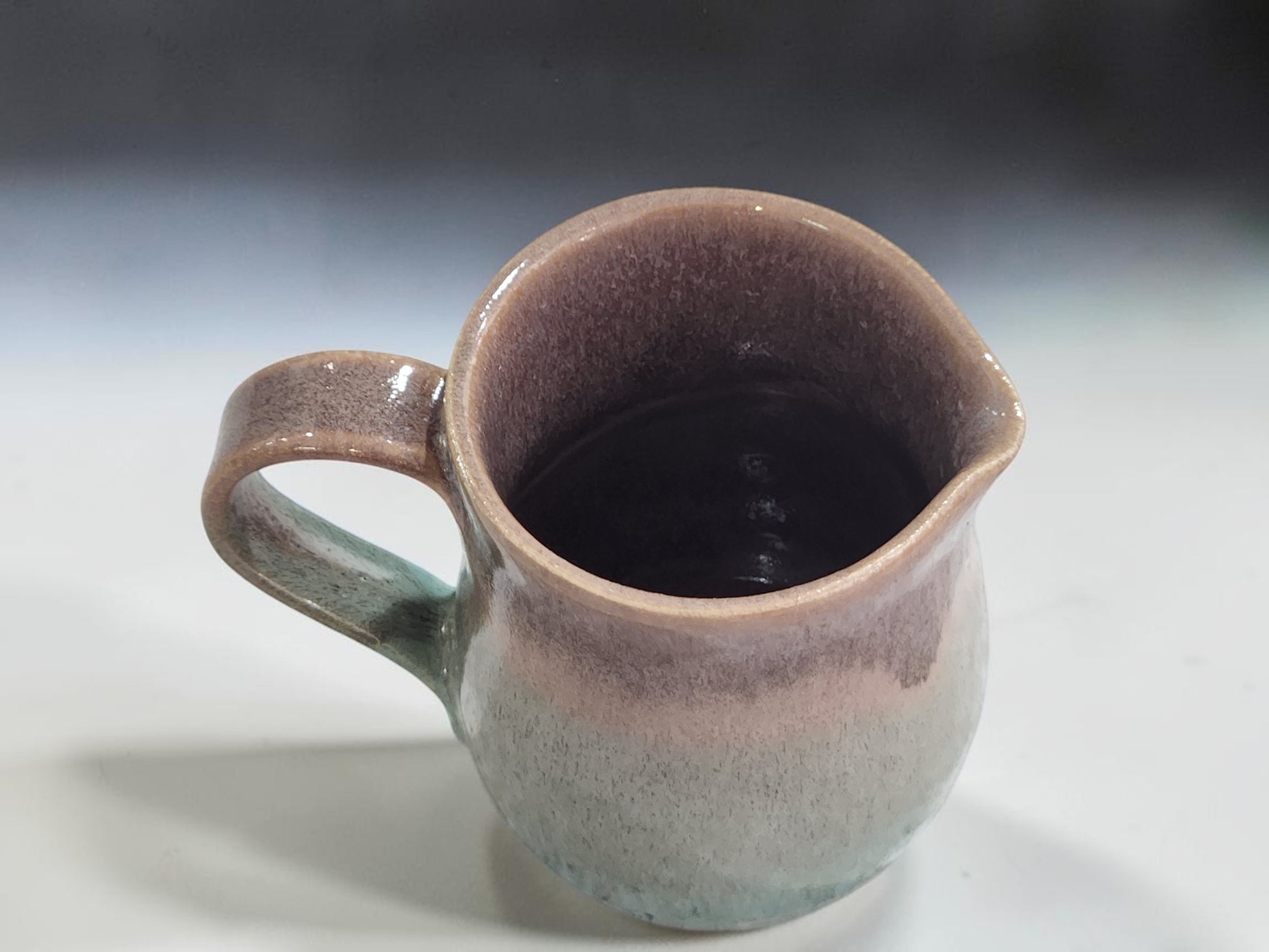 Small ceramic milk jug lined in oatmeal glaze