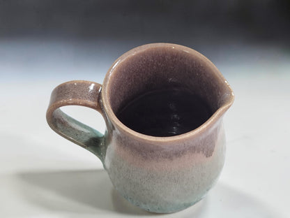 Small ceramic milk jug lined in oatmeal glaze