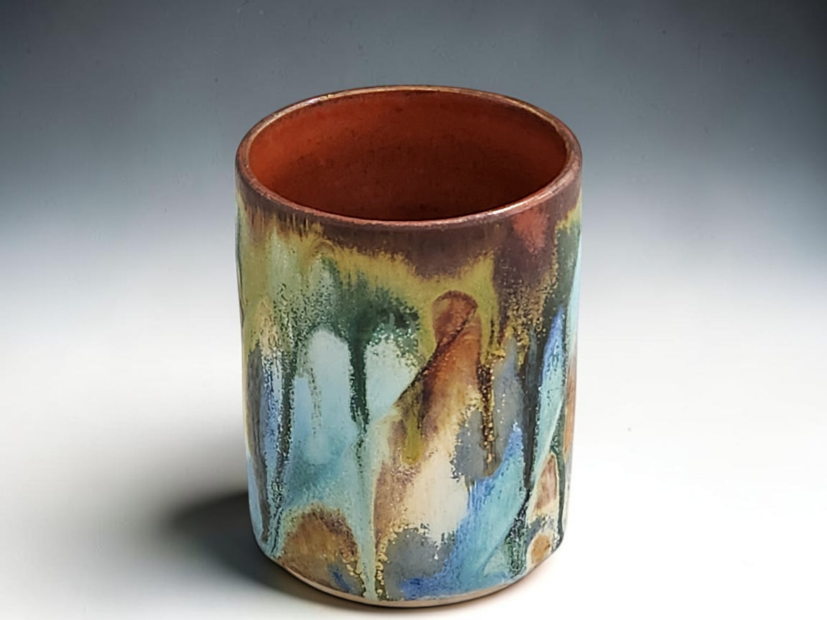 Australian handmade pottery tumbler with colourful layered glaze