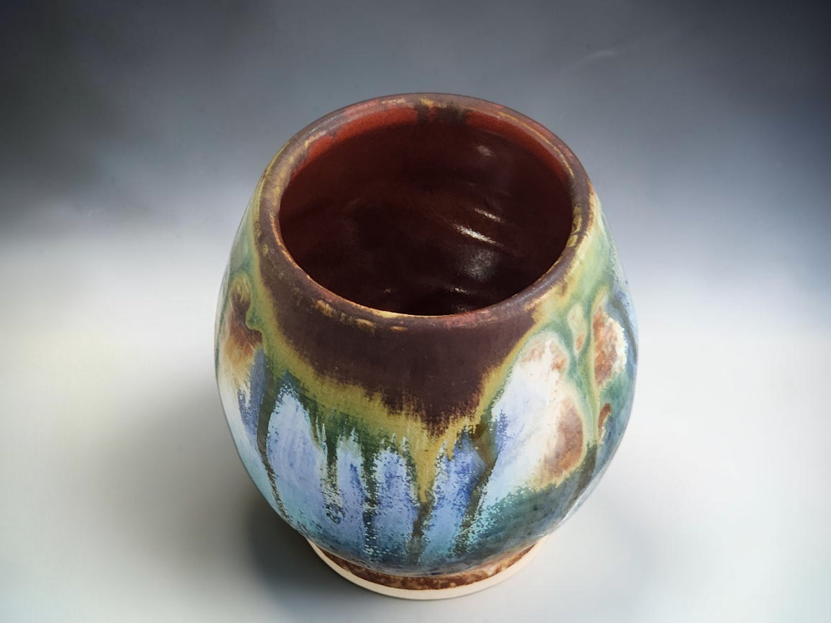 Handmade handleless tea cup with rich brown glazed interior