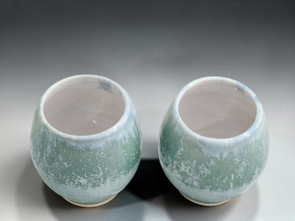 Japanese-inspired handmade tea cups in soft sage green crystalline-style glaze