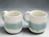 Handmade stoneware coffee mug with cream and green variegated glaze