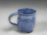 Blue handmade pottery mug by Buxton Pottery on grey studio background