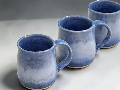 Wheel-thrown blue pottery mug with glossy mottled surface