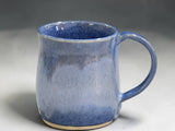 Handmade stoneware coffee mug with blue variegated glaze