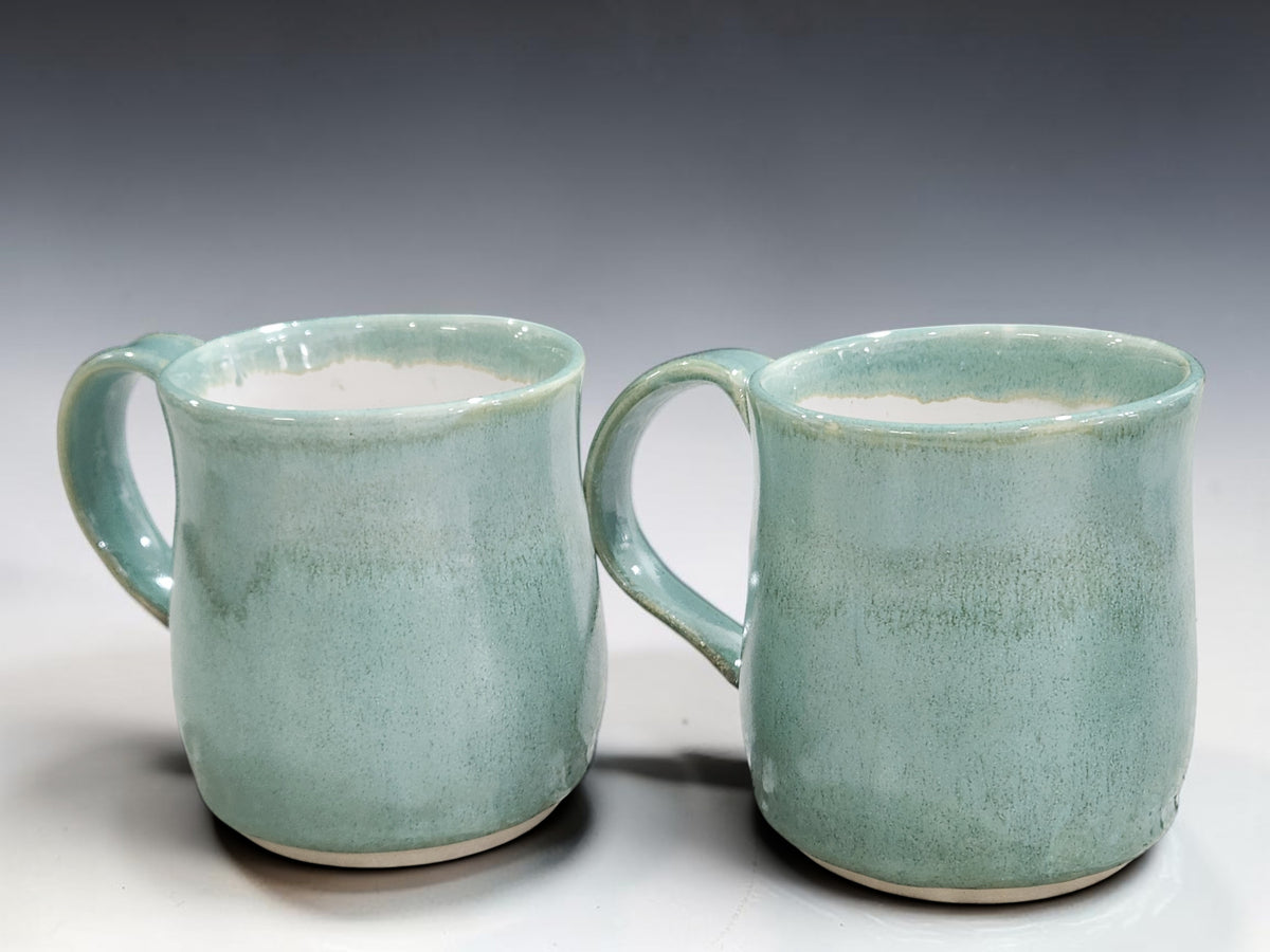 Pair of handmade stoneware coffee mugs in soft spearmint green glaze by Buxton Pottery