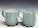 Pair of handmade stoneware coffee mugs in soft spearmint green glaze by Buxton Pottery