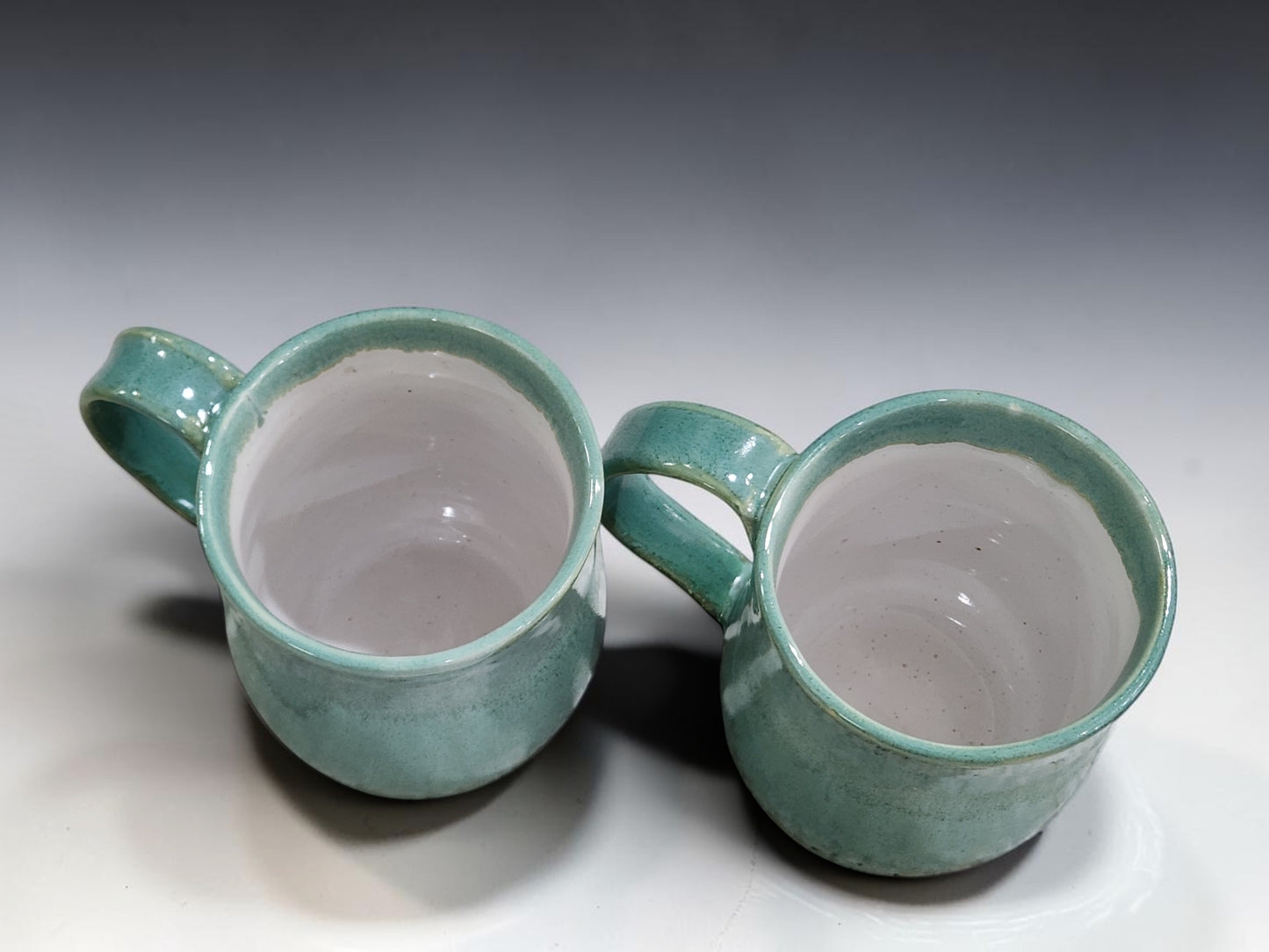 Wheel thrown pottery mugs in soft green glaze for coffee, tea and hot chocolate
