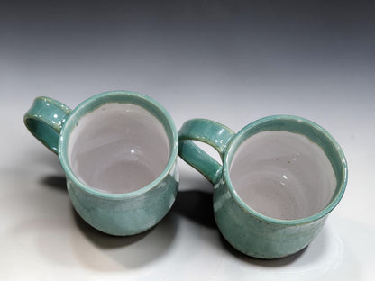 Wheel thrown pottery mugs in soft green glaze for coffee, tea and hot chocolate