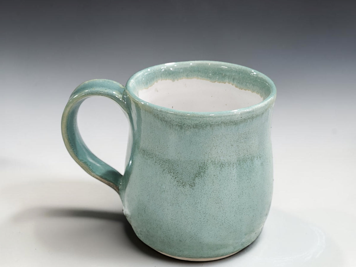 Artisan pottery mugs with comfortable handles in calming spearmint green glaze