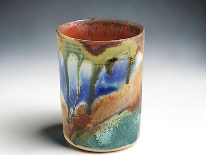Ceramic tumbler showing warm rust brown glazed interior