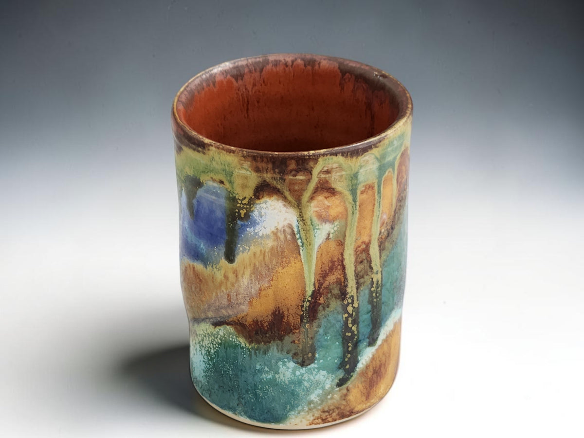 Handmade ceramic cup with blue green ochre and brown glaze