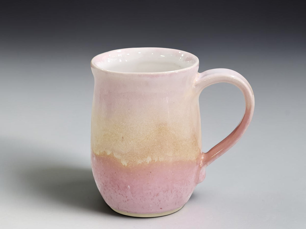 Wheel-thrown ceramic mug measuring 11.5cm tall with an 8cm belly