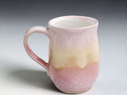 Glossy glazed interior of pink and oatmeal handmade stoneware mug