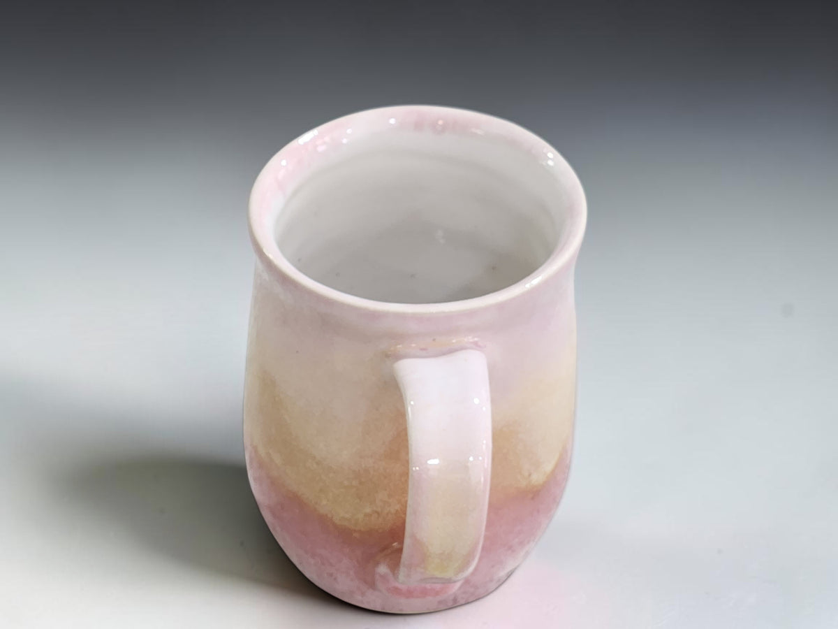 top view of an Australian stoneware coffee mug with soft blush pink and cream glaze