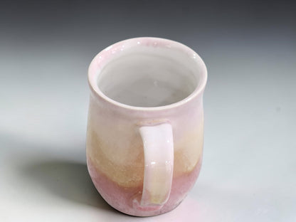 top view of an Australian stoneware coffee mug with soft blush pink and cream glaze