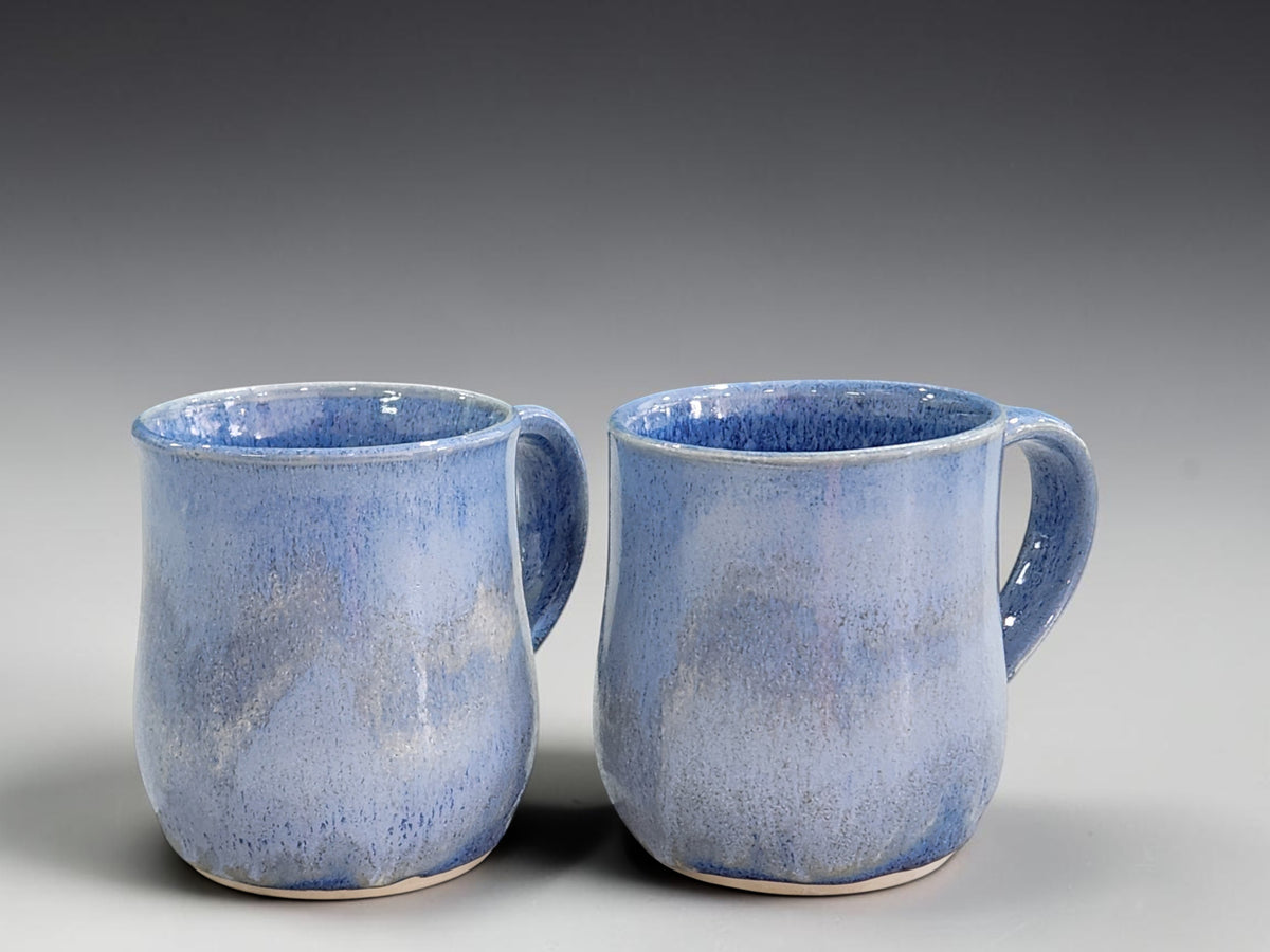 Pair of 350ml blue glazed handmade pottery mugs with softly rounded forms