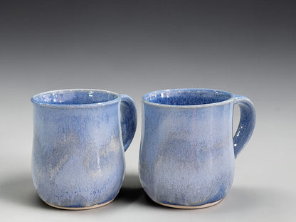 Pair of 350ml blue glazed handmade pottery mugs with softly rounded forms