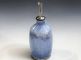 Australian handmade blue ceramic oil dispenser styled with fresh bread, olives and olive oil