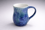 Front view of blue ceramic mug with layered aqua and cobalt glaze